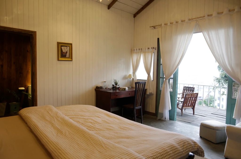 Phòng ngủ DaLat TruLy Home với cửa kính mở ra ban công