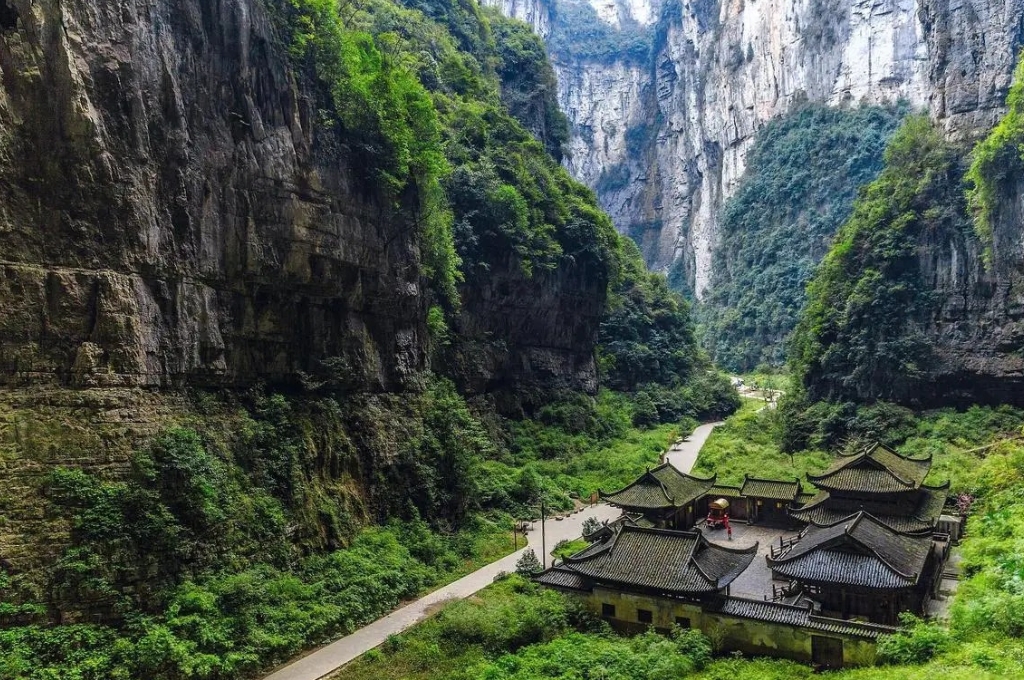 Cảnh quan Thiên Sinh Tam Kiều tại công viên địa chất Vũ Long với vách núi đá vôi và thung lũng xanh.
